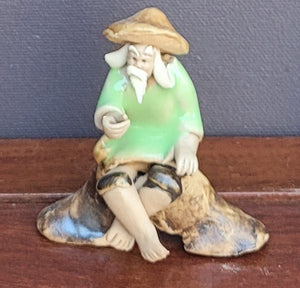 Figurine Fisherman on Rock